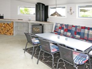 a kitchen with a table and chairs and a fireplace at Holiday Home Rorbu by Interhome in Naustdal i Sunnfjord