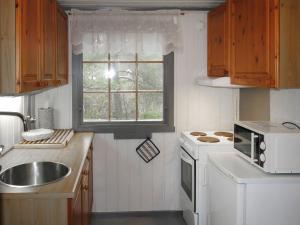 a small kitchen with a sink and a window at Chalet Trygvebu by Interhome in Øyuvstad +23 photos