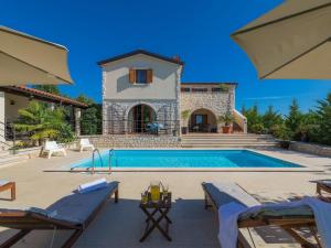 a villa with a swimming pool and a house at Villa Histria 1 by Interhome in Čabrunići