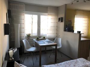 eine Küche mit einem Tisch und Stühlen sowie einem Fenster in der Unterkunft Studioapartment, nahe der Meinhardus-Schanze in Meinerzhagen