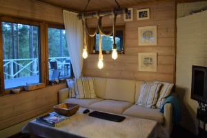 a living room with a couch and a table at Villa Pellinki in Pellinki