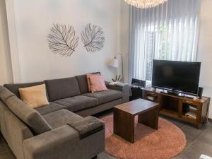 ein Wohnzimmer mit Couch und Flachbildfernseher in der Unterkunft Holiday Home Vuokatinlampi 7 c by Interhome in Lahdenperä