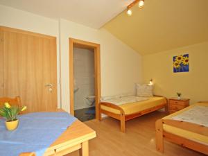a bedroom with two beds and a bathroom at Apartment Stark-2 by Interhome in Pettneu am Arlberg