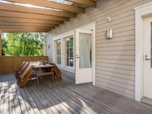 a patio with a table and a door at Holiday Home 4 seasons hymy c by Interhome in Lahdenperä