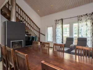 a dining room with a table and chairs and a fireplace at Holiday Home 4 seasons hymy c by Interhome in Lahdenperä