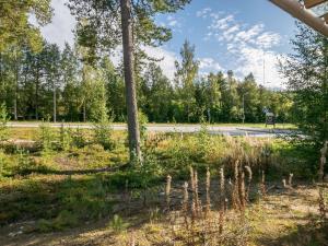 a road with trees on the side of the road at Holiday Home 4 seasons hymy c by Interhome in Lahdenperä