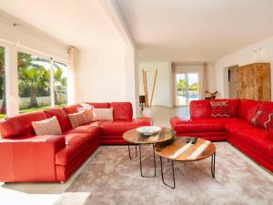 a living room with a red couch and a table at Villa Villa del Maestro by Interhome in Altea la Vieja