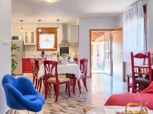 a kitchen and dining room with a table and chairs at Holiday Home Villa Mihael - ROJ540 by Interhome in Žminj