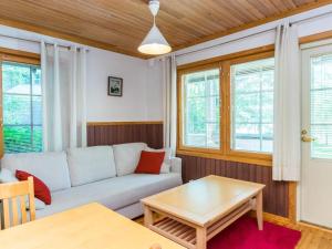 a living room with a couch and a table at Holiday Home Vadelma by Interhome in Kukkola