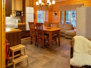 a kitchen and dining room with a table and chairs at Holiday Home Lehtovilla a by Interhome in Äkäslompolo +12 photos