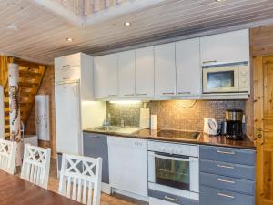 a kitchen with white cabinets and a counter top at Holiday Home Marski by Interhome in Kolinkylä