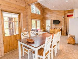a kitchen and dining room with a table and chairs at Holiday Home Marski by Interhome in Kolinkylä