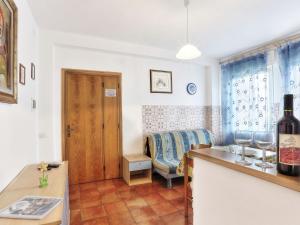 a kitchen with a table with a bottle of wine at Apartment Riviera 8 by Interhome in Marina di Cecina