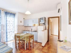 a kitchen and dining room with a table and chairs at Apartment Riviera 8 by Interhome in Marina di Cecina