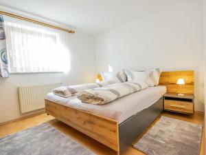 a bedroom with a bed with white walls and a window at Apartment Christine by Interhome in Prutz