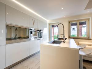a kitchen with white cabinets and a sink at Holiday Home Appendino by Interhome in Serravalle dʼAsti