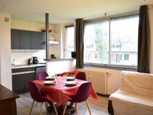 a kitchen and a table with a red table cloth on it at Apartment Les Hauts de Deauville-1 by Interhome in Saint-Arnoult +15 photos