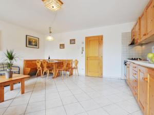 a kitchen and dining room with a table and chairs at Apartment Villa Placidia Apt 21 by Interhome in Campitello di Fassa