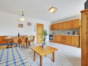 a kitchen and dining room with a table and chairs at Apartment Villa Placidia Apt 21 by Interhome in Campitello di Fassa