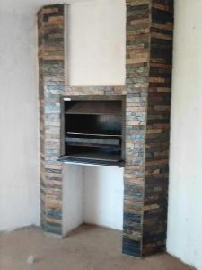 a brick fireplace with an oven in a wall at Kingdoms Place Guesthouse in Ga-Luka