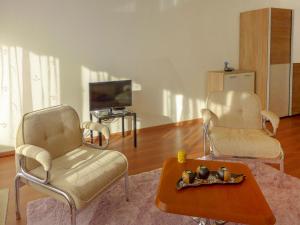 a living room with two chairs and a coffee table at Studio Eperon B 22 by Interhome in Crans-Montana +29 photos