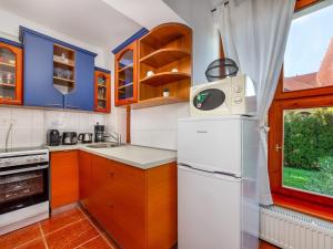 a kitchen with a white refrigerator and a window at Holiday Home Kamilla by Interhome in Balatonberény