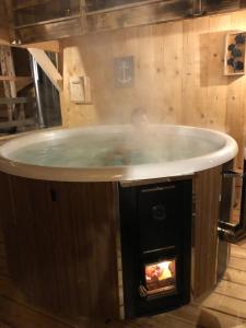 a hot tub in a room with a fireplace at Apartment Gurkhof-1 by Interhome in Gnesau