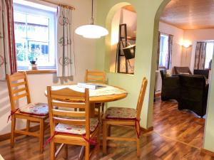 a dining room and living room with a table and chairs at Apartment Ferienwohnung Gurkhof 1 - Nockhaus by Interhome in Gnesau +9 photos