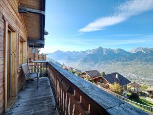 a balcony of a house with a view of mountains at Chalet Le Dahu by Interhome in Veysonnaz