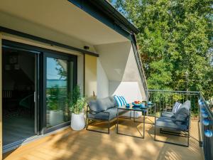 a patio with two chairs and a table on a deck at Apartment Erika by Interhome in Balatonszárszó