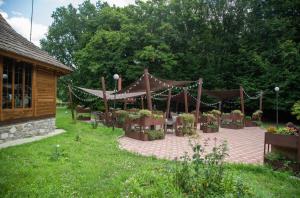 a gazebo with chairs and plants in a yard at Optima Collection Aquadar in Manʼkivka
