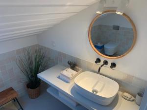 a bathroom with a sink and a mirror at Lovely 2-bedroom apartment- Comporta in Carvalhal