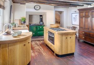 a kitchen with green cabinets and a stove top oven at The Candlemakers in Hexham