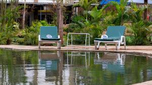 a child sitting in two chairs next to a body of water at Hotel Tobriana in Nairobi