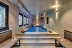 a swimming pool in a room with stairs and a swimming pool at Chalet Carte Blanche Monts in Tignes