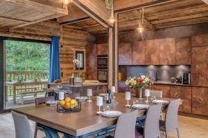 a kitchen and dining room with a table and chairs at Chalet Carte Blanche Monts in Tignes