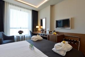 a hotel room with two towels on a bed at Holiday Inn Bursa - City Centre by IHG in Bursa