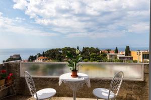 a table and chairs on a balcony with a view at Studio Maha in Dubrovnik