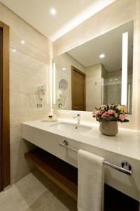 a bathroom with a sink and a large mirror at Holiday Inn Bursa - City Centre by IHG in Bursa