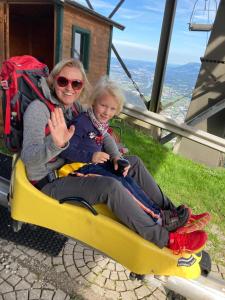 a woman and a little girl sitting on a ski lift at Haus Fercher in Grossarl