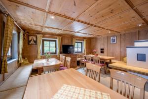 een kamer met houten muren en tafels en stoelen bij Peater's Hoamat in Sölden