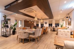 a dining room with wooden tables and chairs at Hotel Molenzicht in Nes