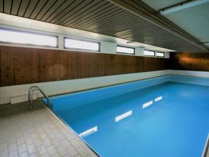 ein Pool mit blauem Wasser in einem Gebäude in der Unterkunft Studio Panorama by Interhome in Les Collons