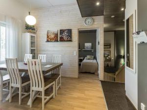 a kitchen and dining room with a table and chairs at Holiday Home Levin stara a04 by Interhome in Sirkka