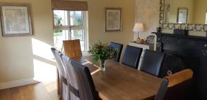 a dining room with a wooden table and chairs at Relax at Safe Haven in Carlingford