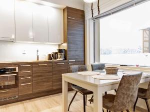 a kitchen with a white table and chairs at Holiday Home Tunturinlaita c3 by Interhome in Sirkka