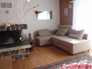 a living room with a couch and a fireplace at Apartment Schwalbe by Interhome in Adelboden