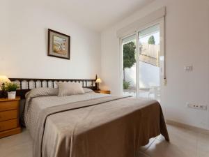 a white bedroom with a large bed and a window at Holiday Home Sascha by Interhome in Peñíscola