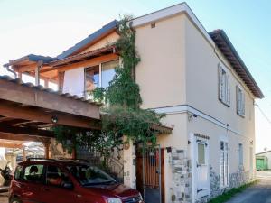 a red car parked in front of a white house at Apartment Marina 2 by Interhome in Piani di Vallecrosia