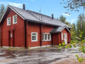 a red house with a black roof at Holiday Home Porukka 1 by Interhome in Sirkka